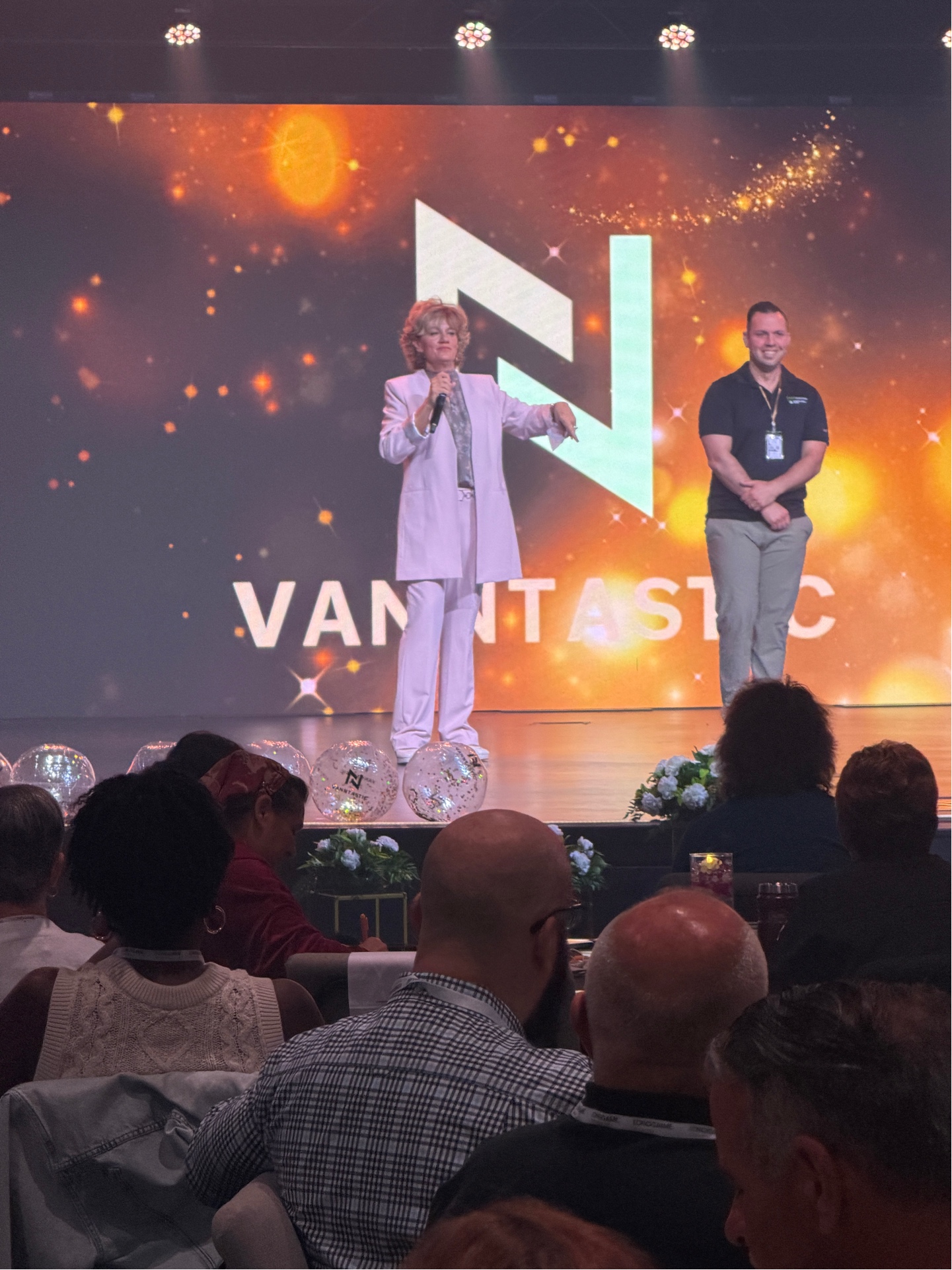 Christy Vann speaking on stage at conference